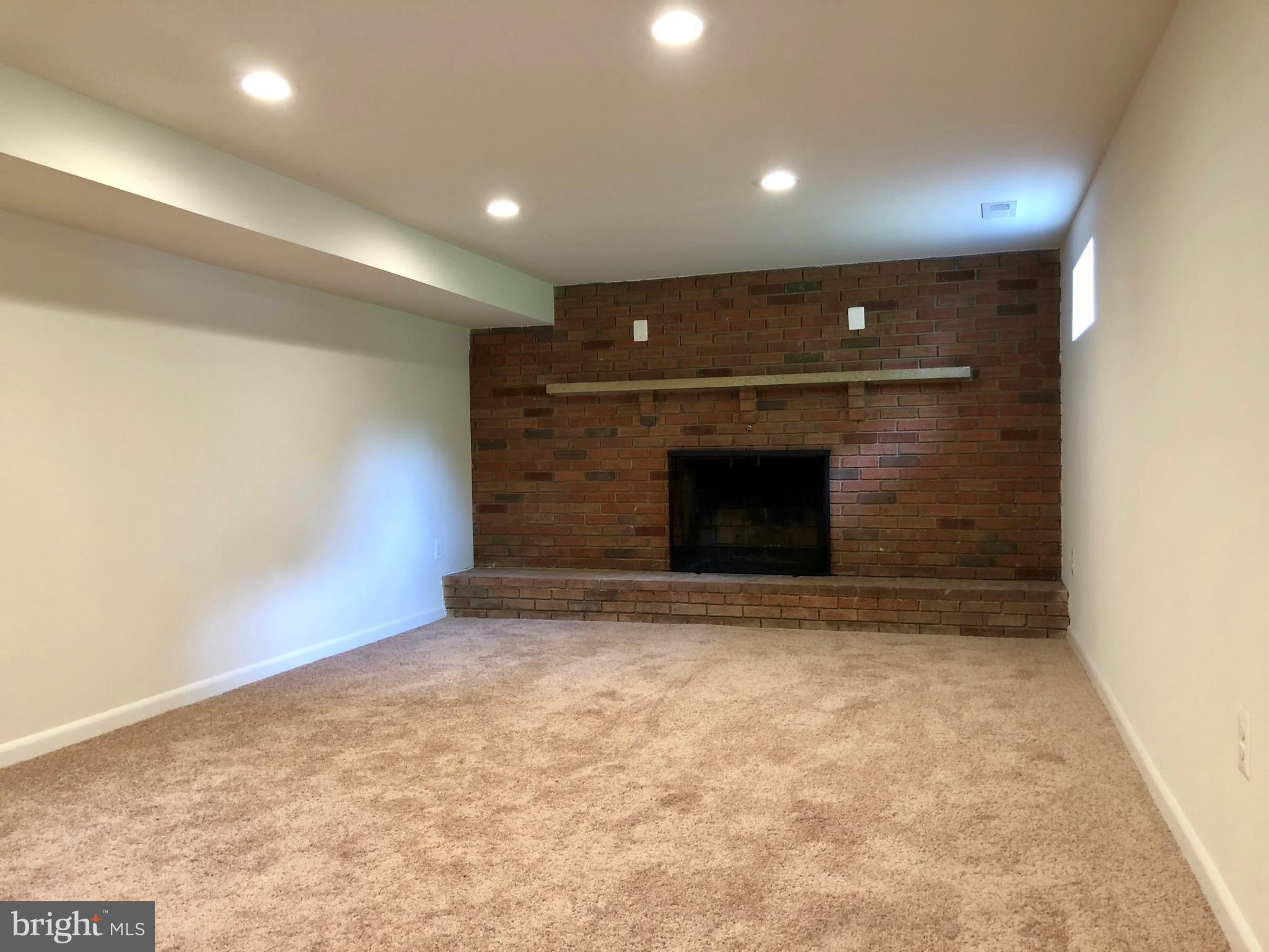 10826 Old Annapolis Road Frederick, MD 21701 - Photo 13 of 23 FINISHED REC ROOM WITH WOOD BURNING FIREPLACE