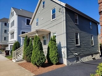 321 East Street Dedham, MA 02026 - Photo 2 of 18 a front view of a house with garden