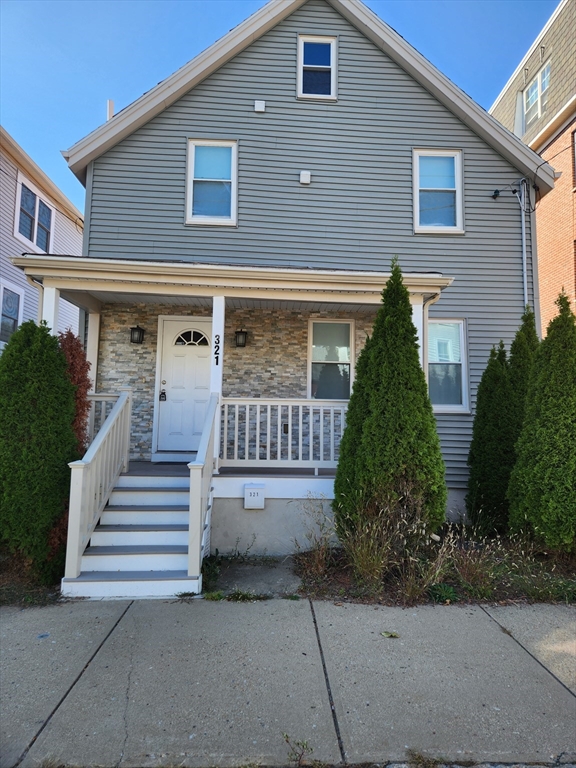 321 East Street Dedham, MA 02026 - Photo 3 of 18 a front view of a house with a garden