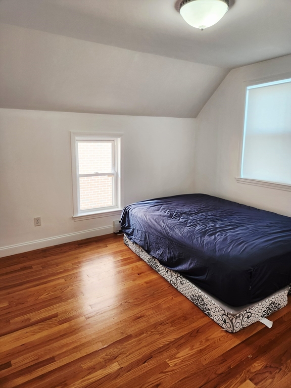 321 East Street Dedham, MA 02026 - Photo 10 of 18 a bedroom with a bed and wooden floor