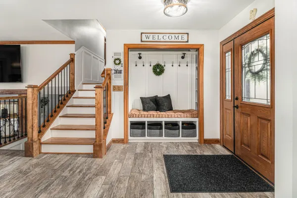 a view of entryway and hall with wooden floor