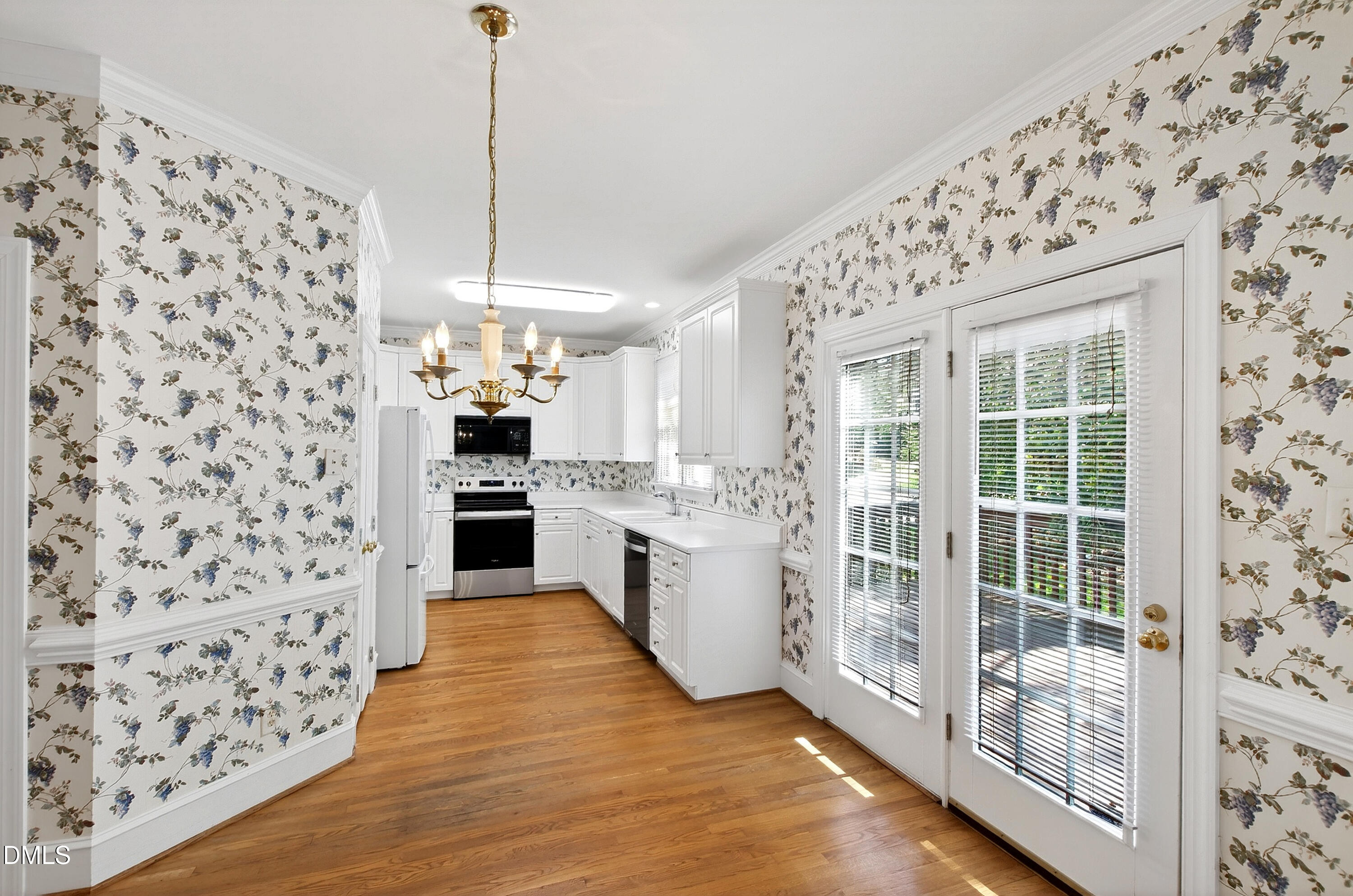 913 Tanworth Drive Raleigh, NC 27615 - Photo 15 of 48 a kitchen with granite countertop a refrigerator and a stove top oven