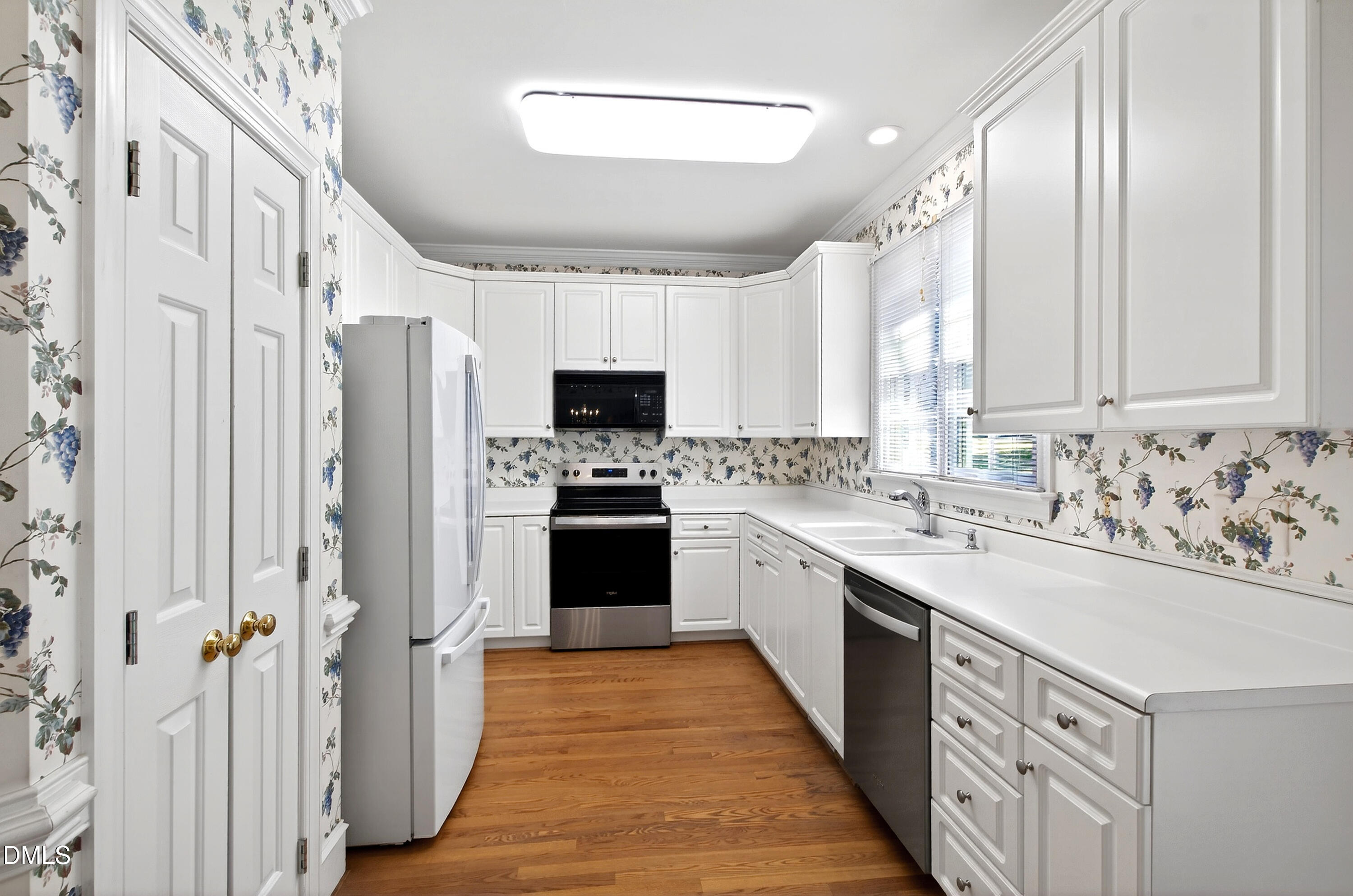 913 Tanworth Drive Raleigh, NC 27615 - Photo 16 of 48 a kitchen with stainless steel appliances sink refrigerator and microwave
