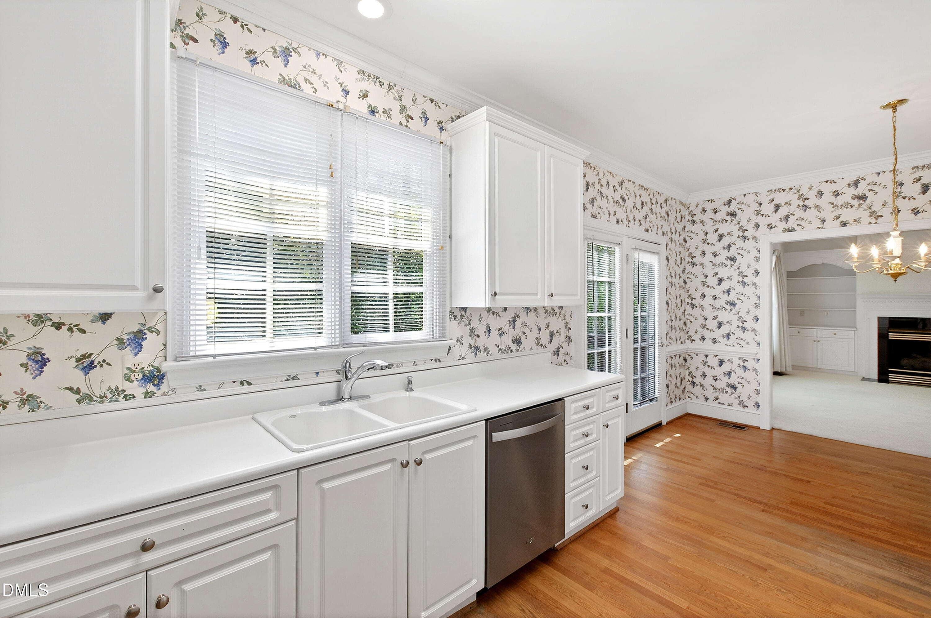 913 Tanworth Drive Raleigh, NC 27615 - Photo 19 of 48 a kitchen with a sink cabinets appliances and a large window