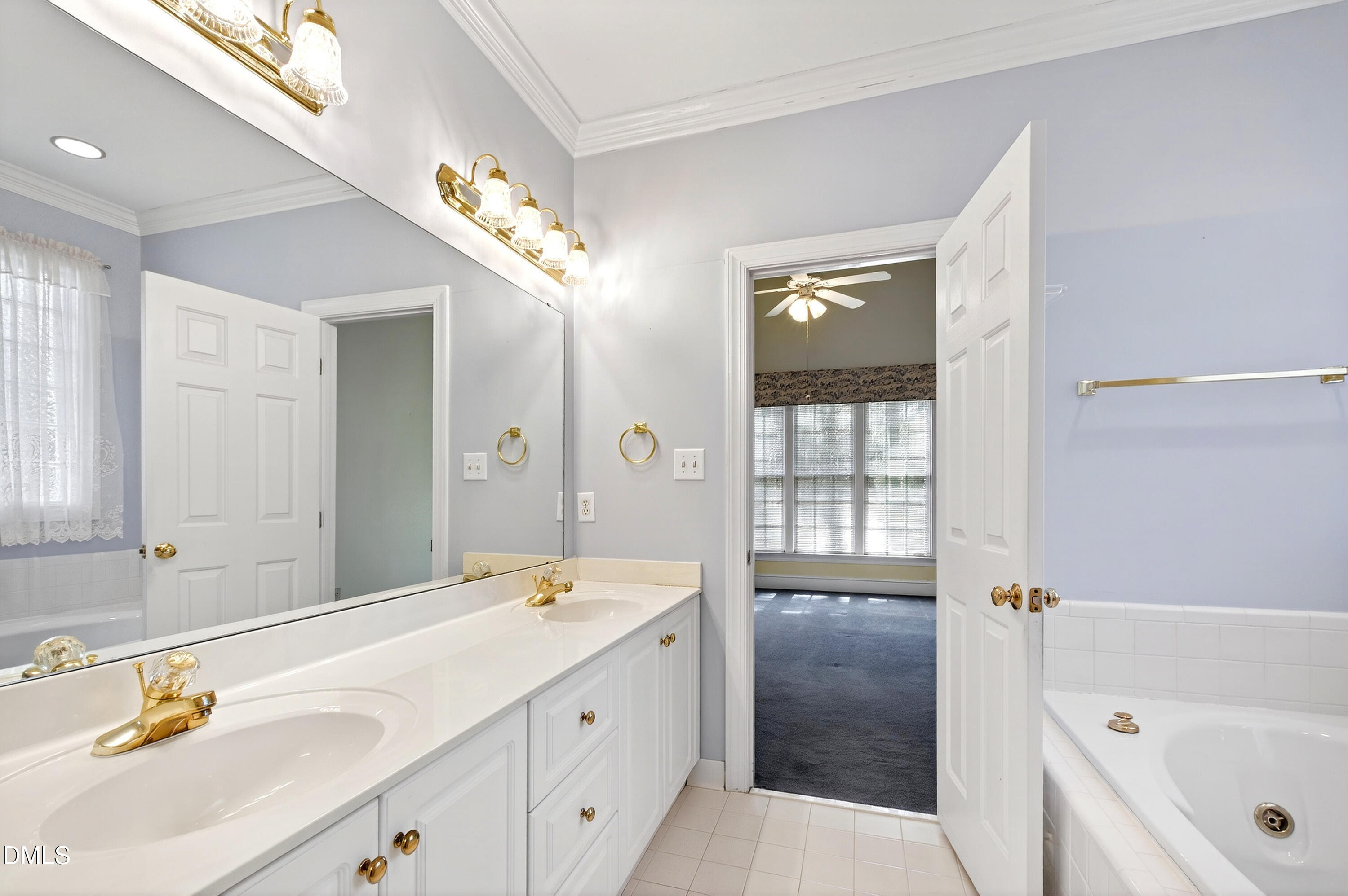913 Tanworth Drive Raleigh, NC 27615 - Photo 24 of 48 a spacious bathroom with a tub a sink and mirror