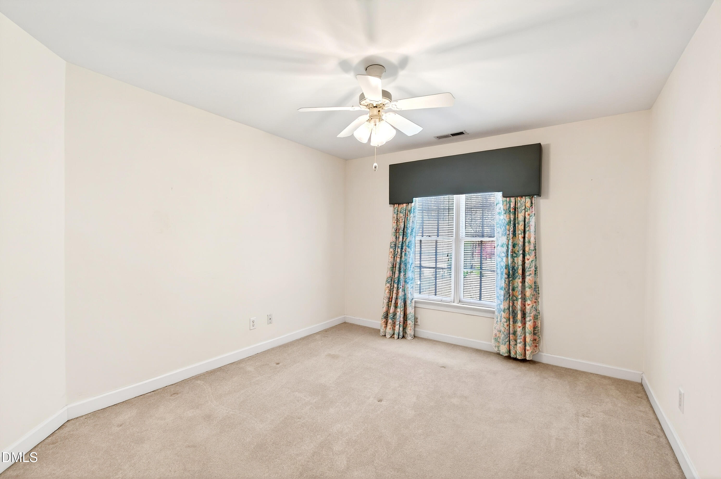 913 Tanworth Drive Raleigh, NC 27615 - Photo 29 of 48 an empty room with chandelier fan and windows