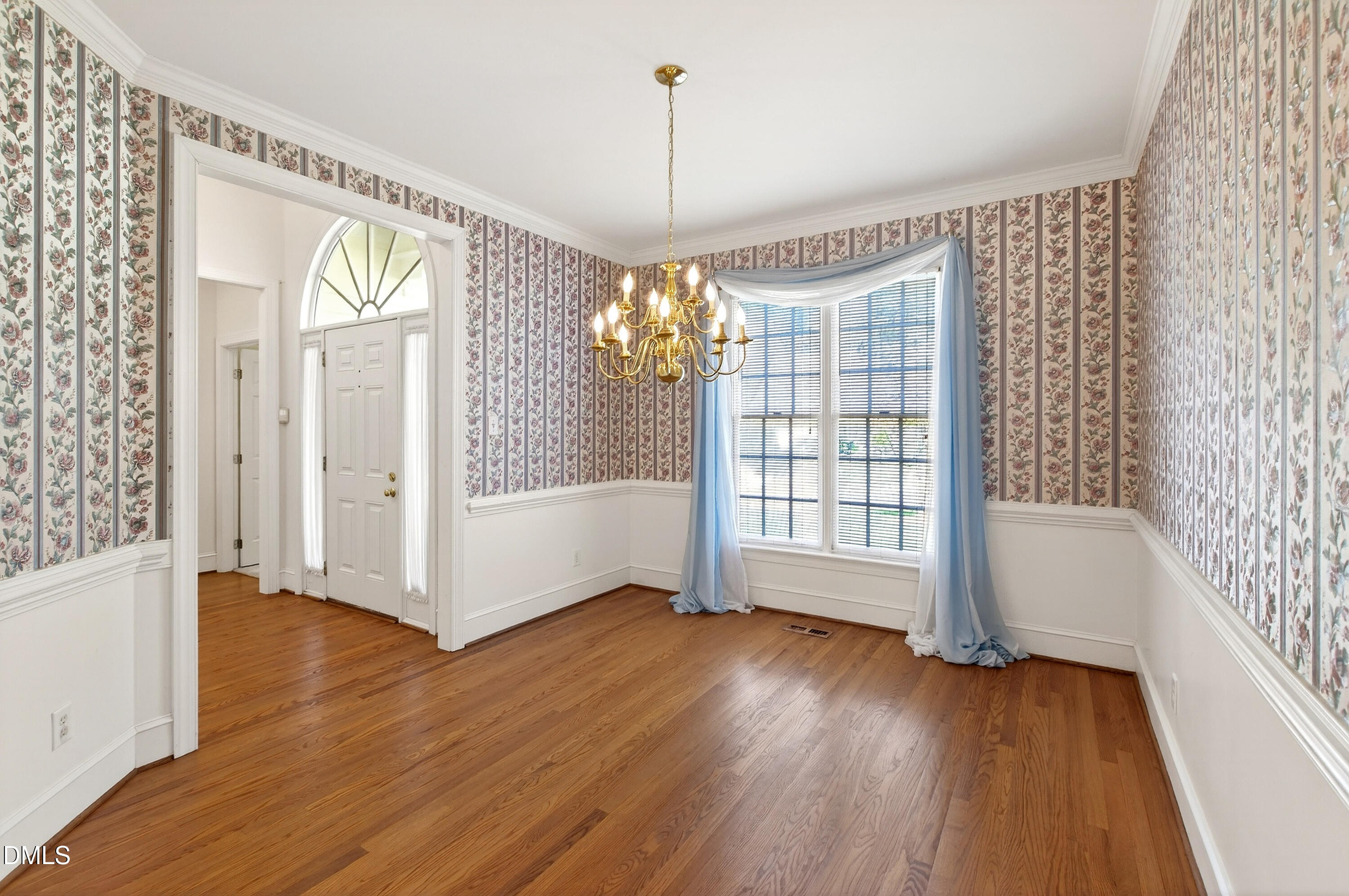 913 Tanworth Drive Raleigh, NC 27615 - Photo 8 of 48 a view of an empty room with wooden floor and a window