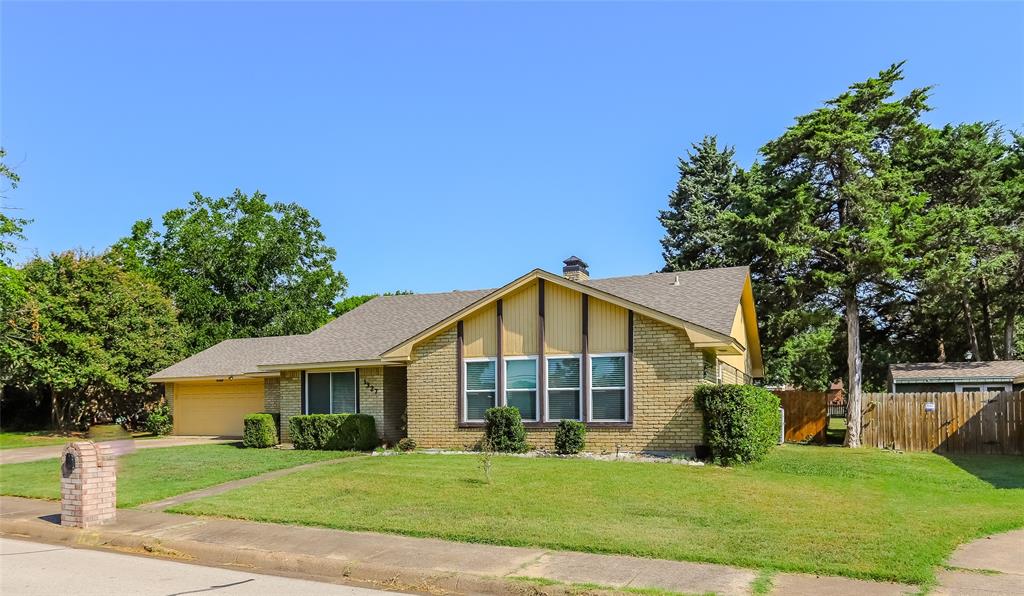 a view of a big house with a big yard and potted plants