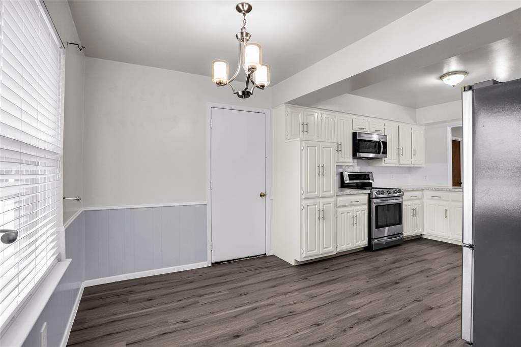1327 Big Stone Gap Road Duncanville, TX 75137 - Photo 22 of 36 a kitchen with a refrigerator and a stove top oven
