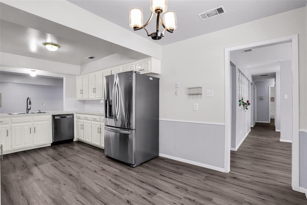1327 Big Stone Gap Road Duncanville, TX 75137 - Photo 23 of 36 a kitchen with a refrigerator and a stove top oven