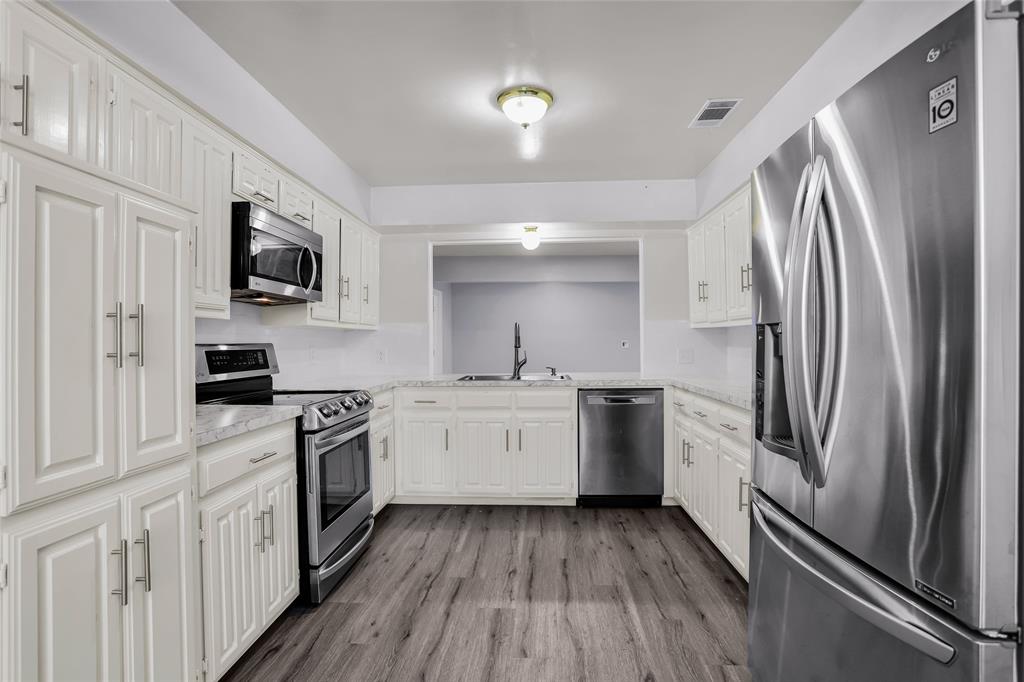 1327 Big Stone Gap Road Duncanville, TX 75137 - Photo 24 of 36 a kitchen with a refrigerator stove and sink