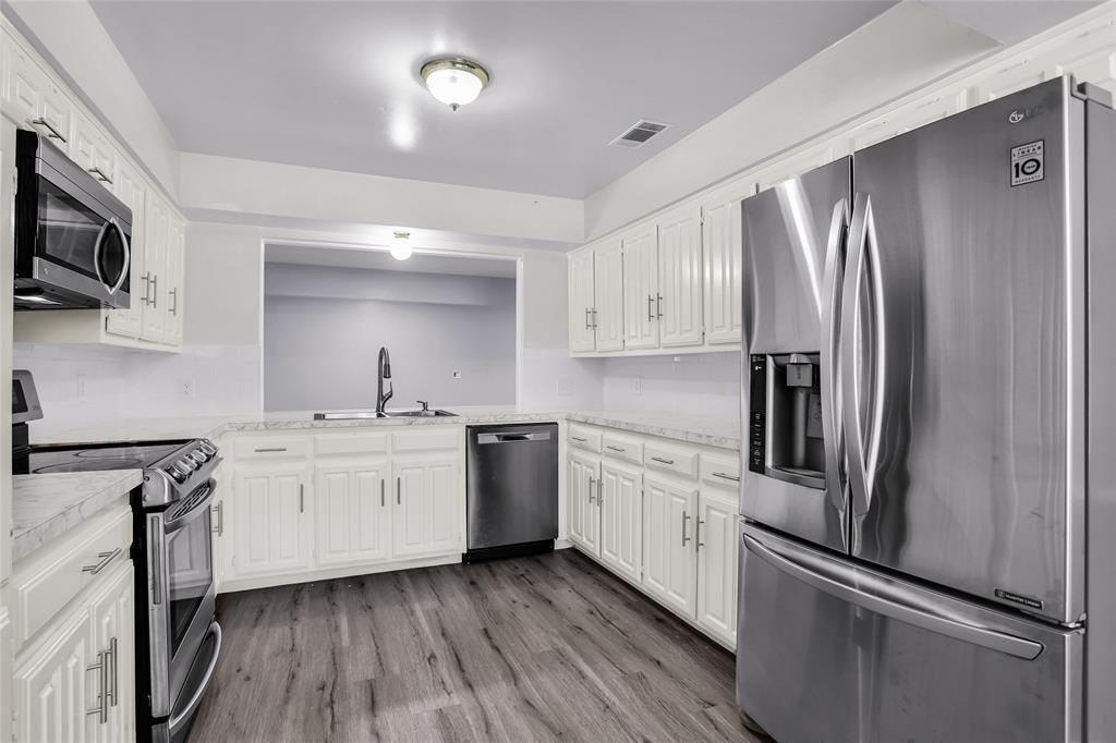 1327 Big Stone Gap Road Duncanville, TX 75137 - Photo 25 of 36 a kitchen with granite countertop stainless steel appliances a refrigerator stove top oven and sink