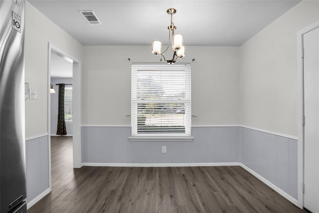 1327 Big Stone Gap Road Duncanville, TX 75137 - Photo 26 of 36 an empty room with wooden floor and windows