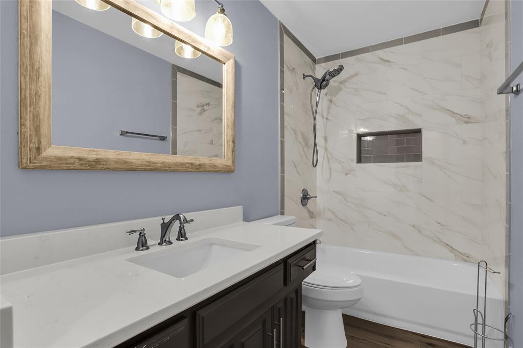 1327 Big Stone Gap Road Duncanville, TX 75137 - Photo 31 of 36 a bathroom with a sink a toilet and shower