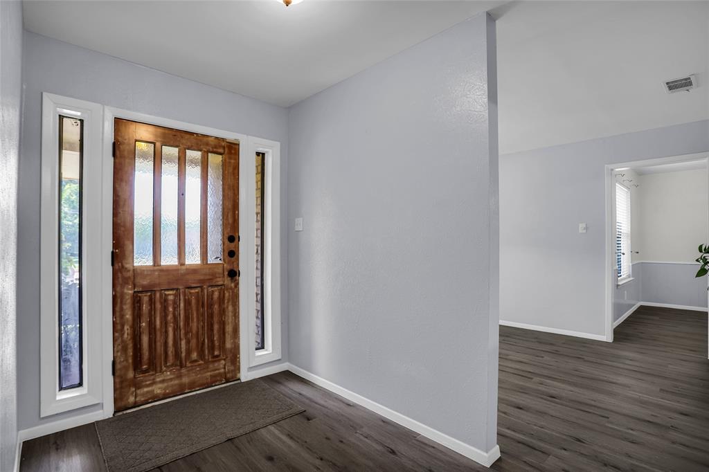 1327 Big Stone Gap Road Duncanville, TX 75137 - Photo 6 of 36 a view of a hallway with wooden floor and a window