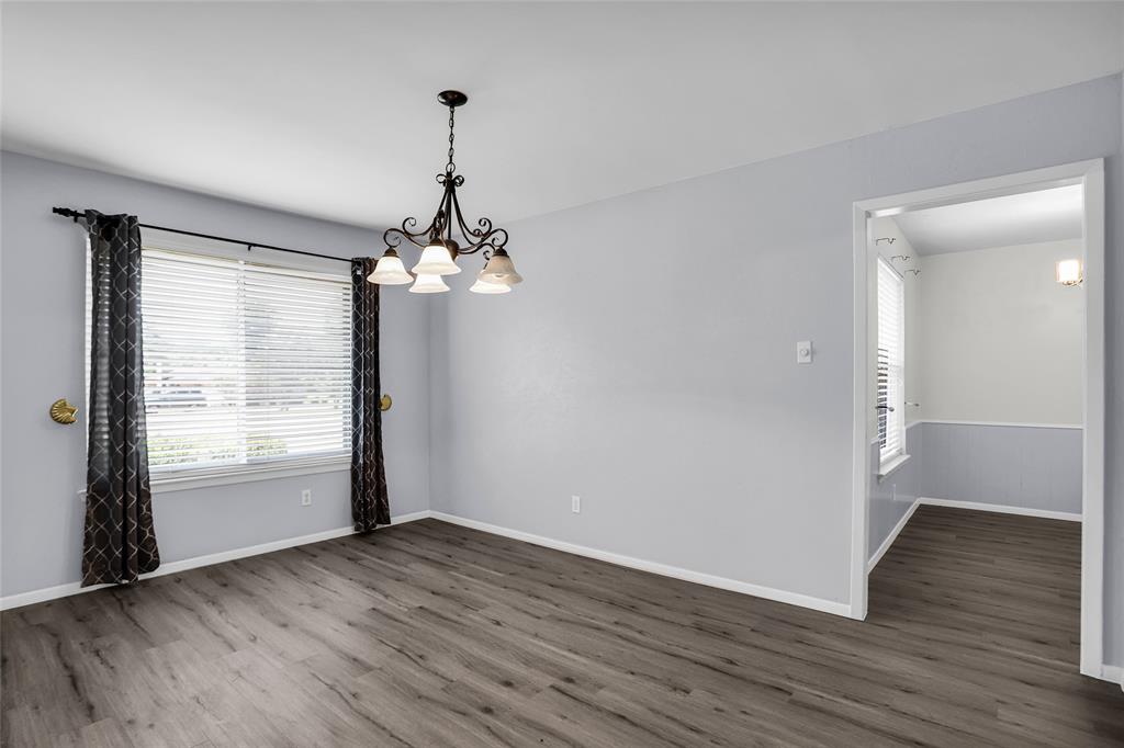 1327 Big Stone Gap Road Duncanville, TX 75137 - Photo 7 of 36 an empty room with wooden floor and windows