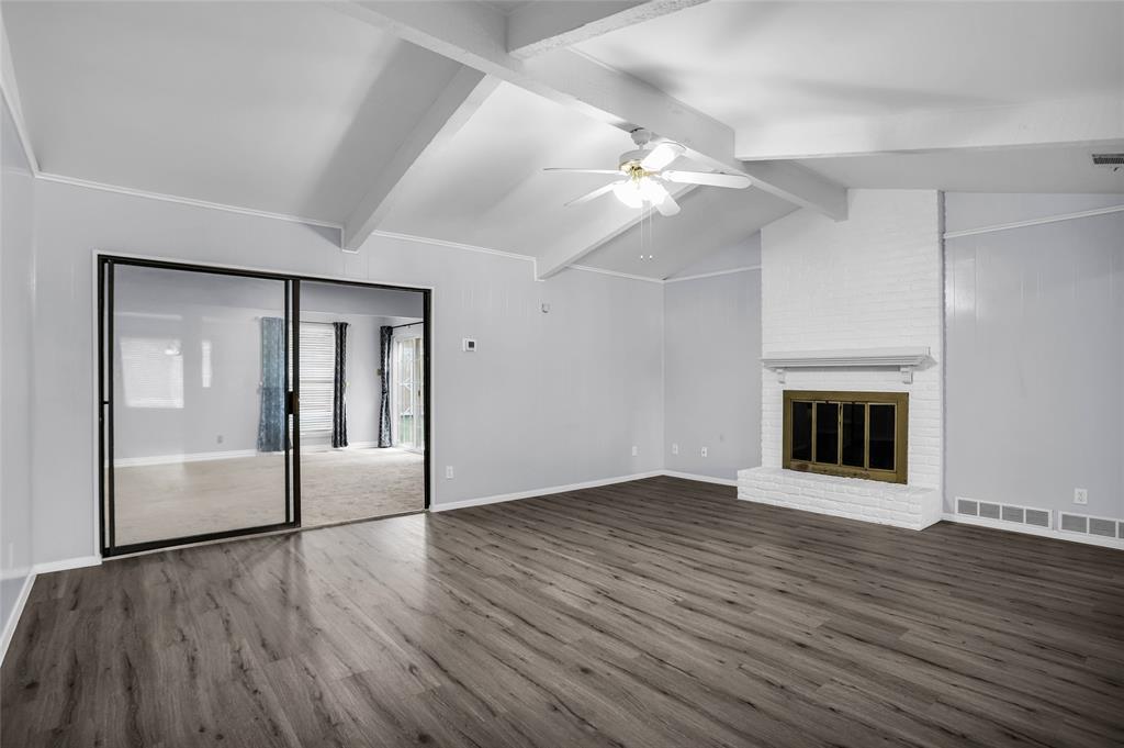 1327 Big Stone Gap Road Duncanville, TX 75137 - Photo 9 of 36 an empty room with wooden floor and chandelier fan