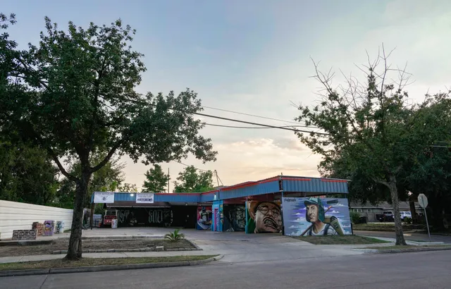 a view of a water fountain and tree s