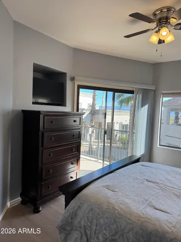 a view of a house with wooden fence and two windows