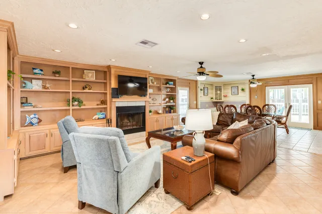 a living room with furniture a fireplace and a flat screen tv