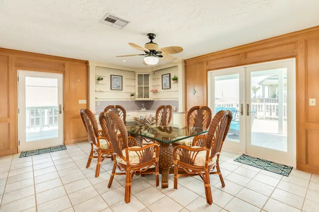 a view of a dining room with furniture and a chandelier