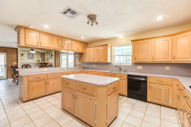 a kitchen with cabinets appliances a sink and a counter top space