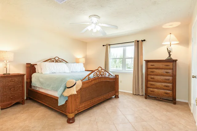a spacious bedroom with a bed and a chandelier
