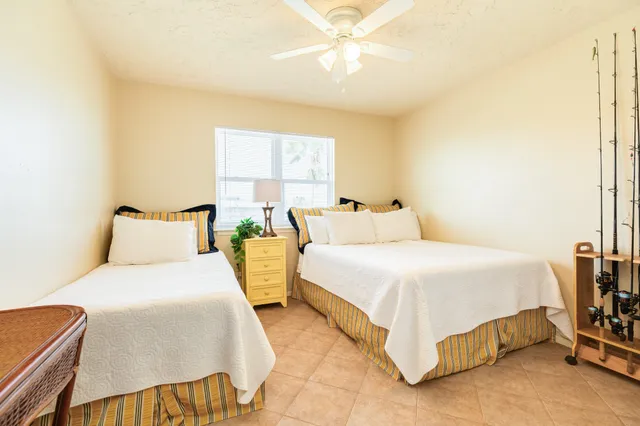 a bedroom with bed and a chandelier