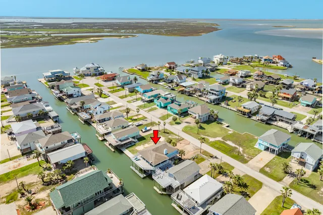an aerial view of a house with a lake view