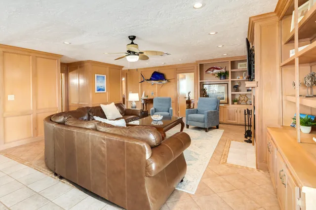 a living room with stainless steel appliances kitchen island granite countertop furniture a rug and a view of kitchen