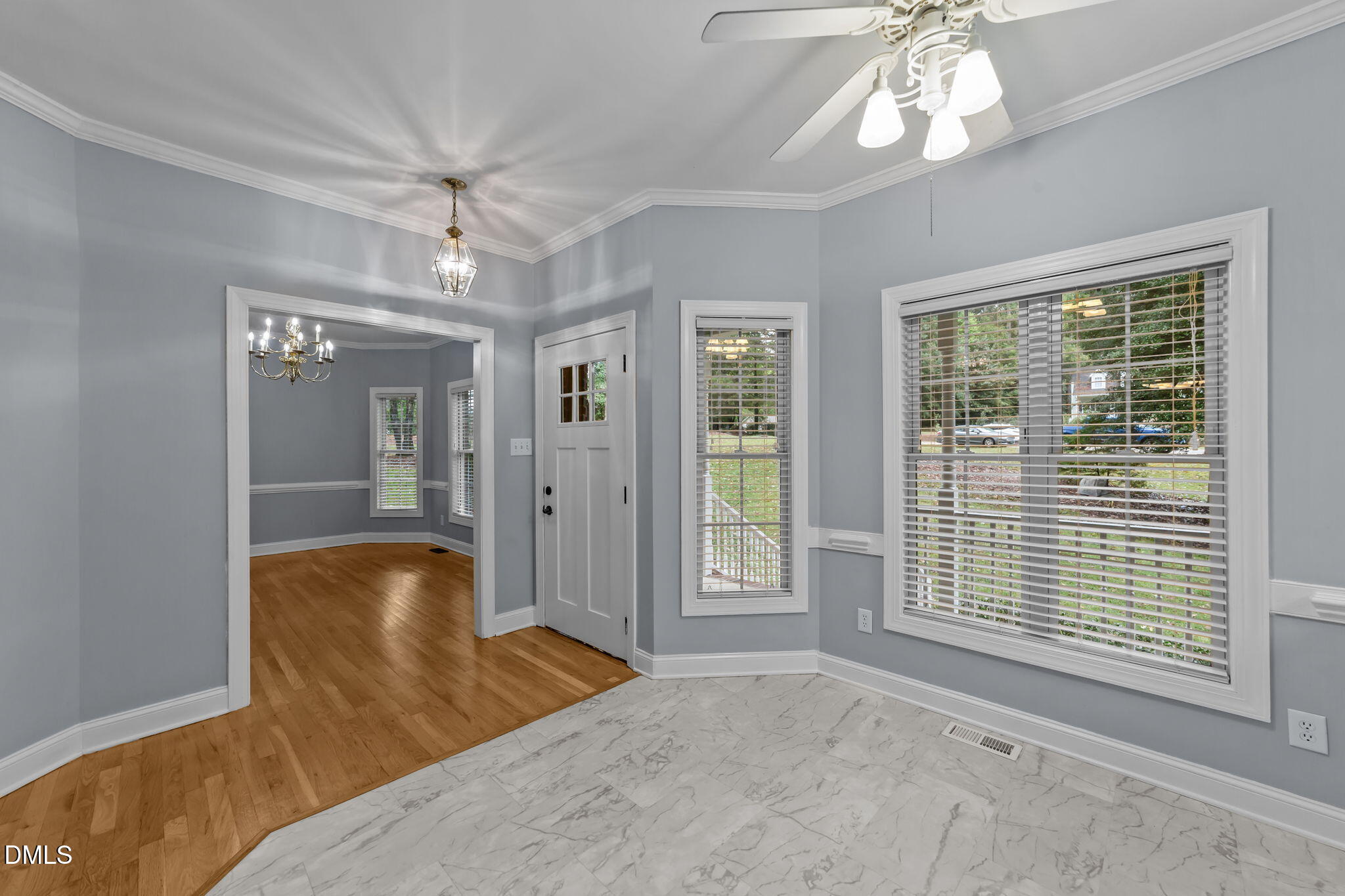 208 Adams Court Clayton, NC 27520 - Photo 14 of 63 a spacious bedroom with a large bed and a chandelier