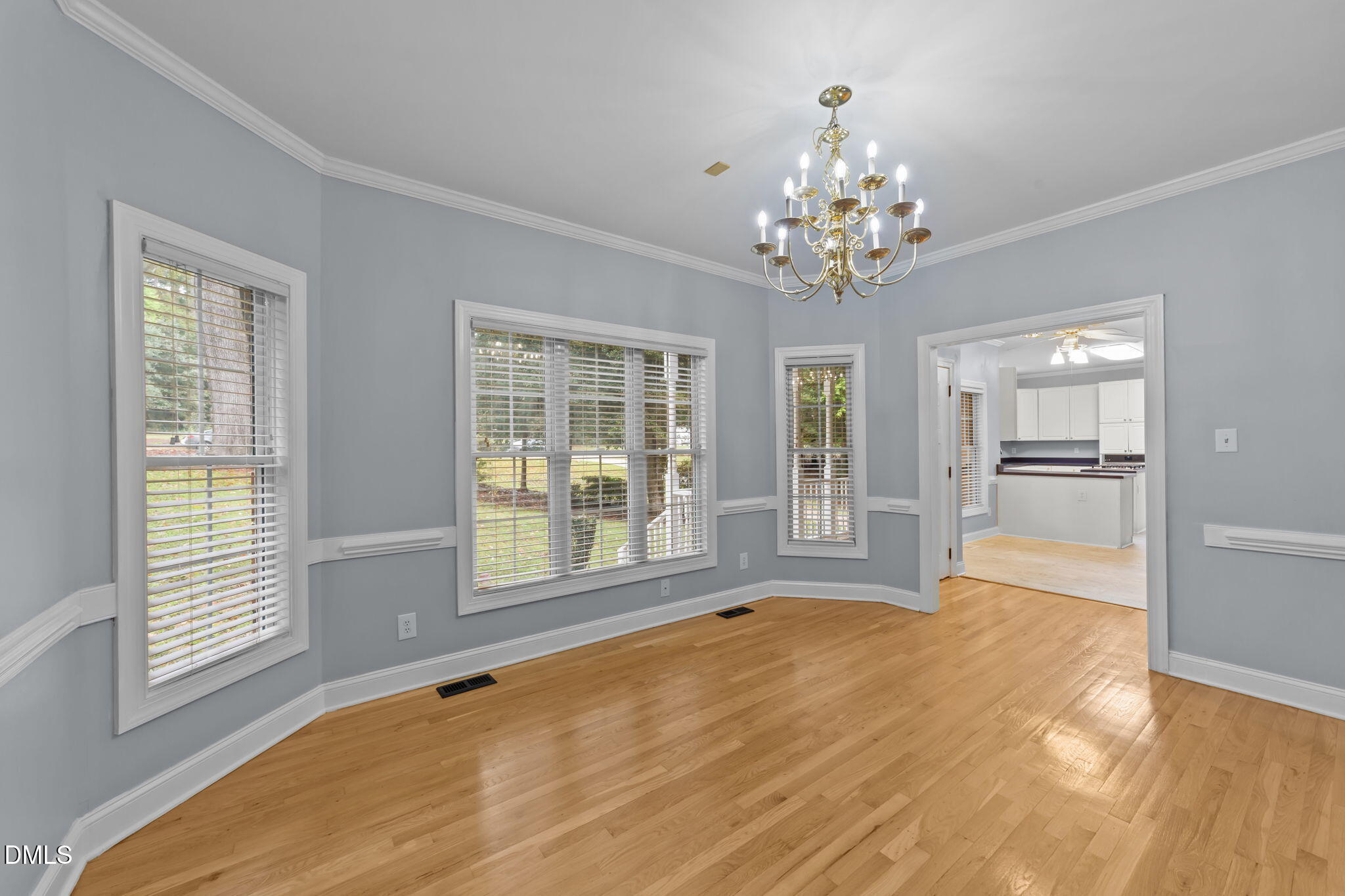208 Adams Court Clayton, NC 27520 - Photo 16 of 63 a view of an empty room with a window and a kitchen