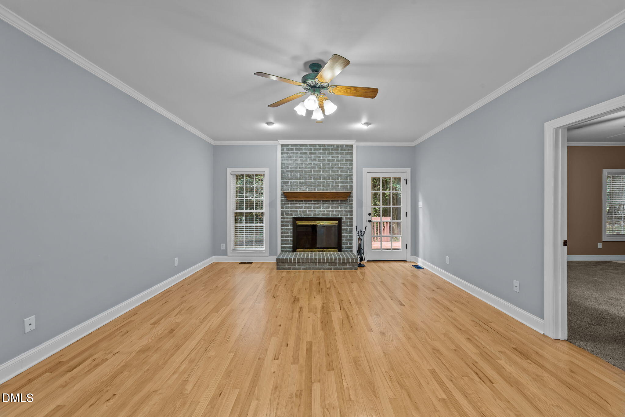 208 Adams Court Clayton, NC 27520 - Photo 19 of 63 a view of an empty room with a fireplace and a window