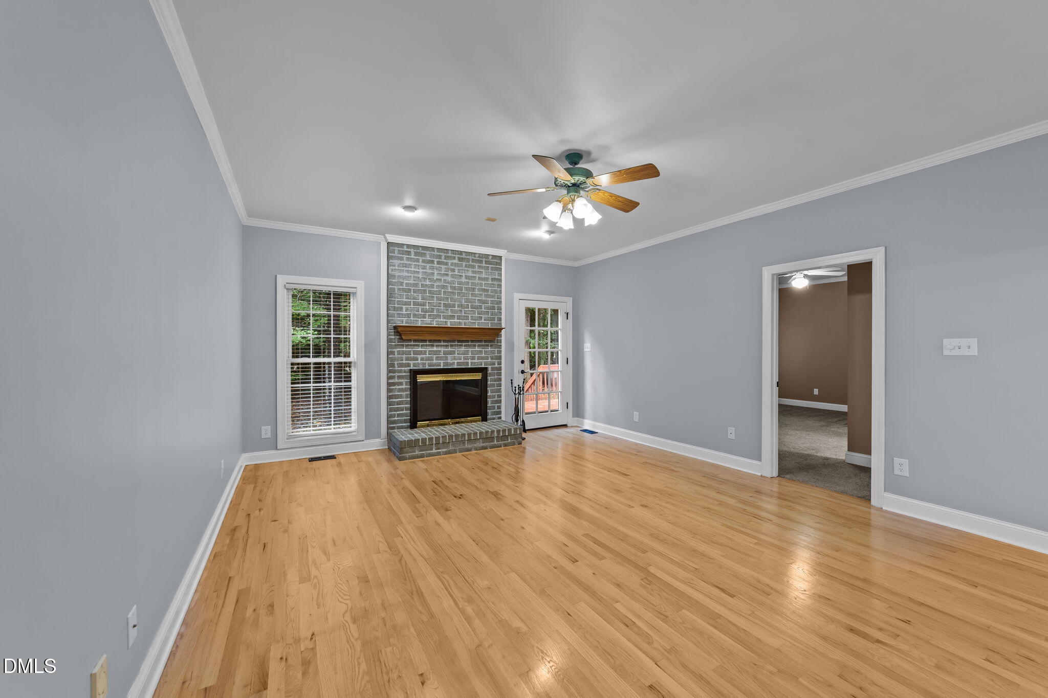 208 Adams Court Clayton, NC 27520 - Photo 20 of 63 a view of empty room with wooden floor and fireplace