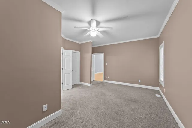a view of walk in closet with empty racks