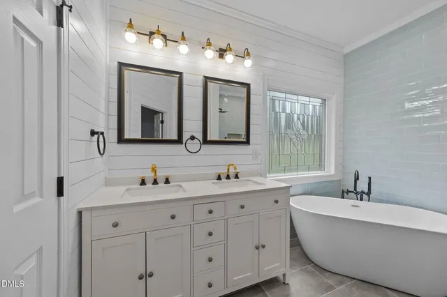 a bathroom with a granite countertop toilet sink and mirror