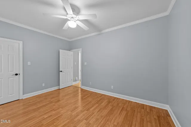 a view of empty room with wooden floor
