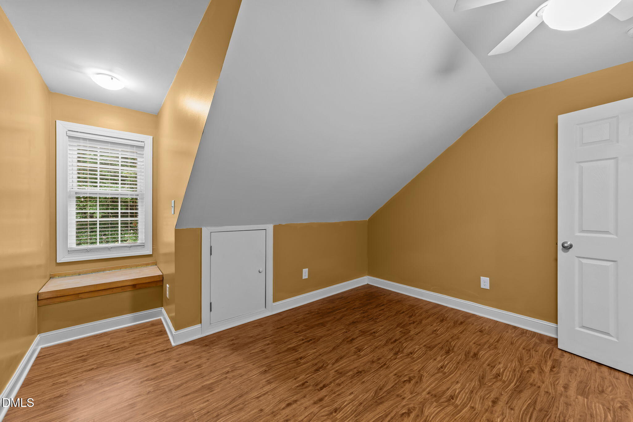 208 Adams Court Clayton, NC 27520 - Photo 36 of 63 an empty room with wooden floor and windows