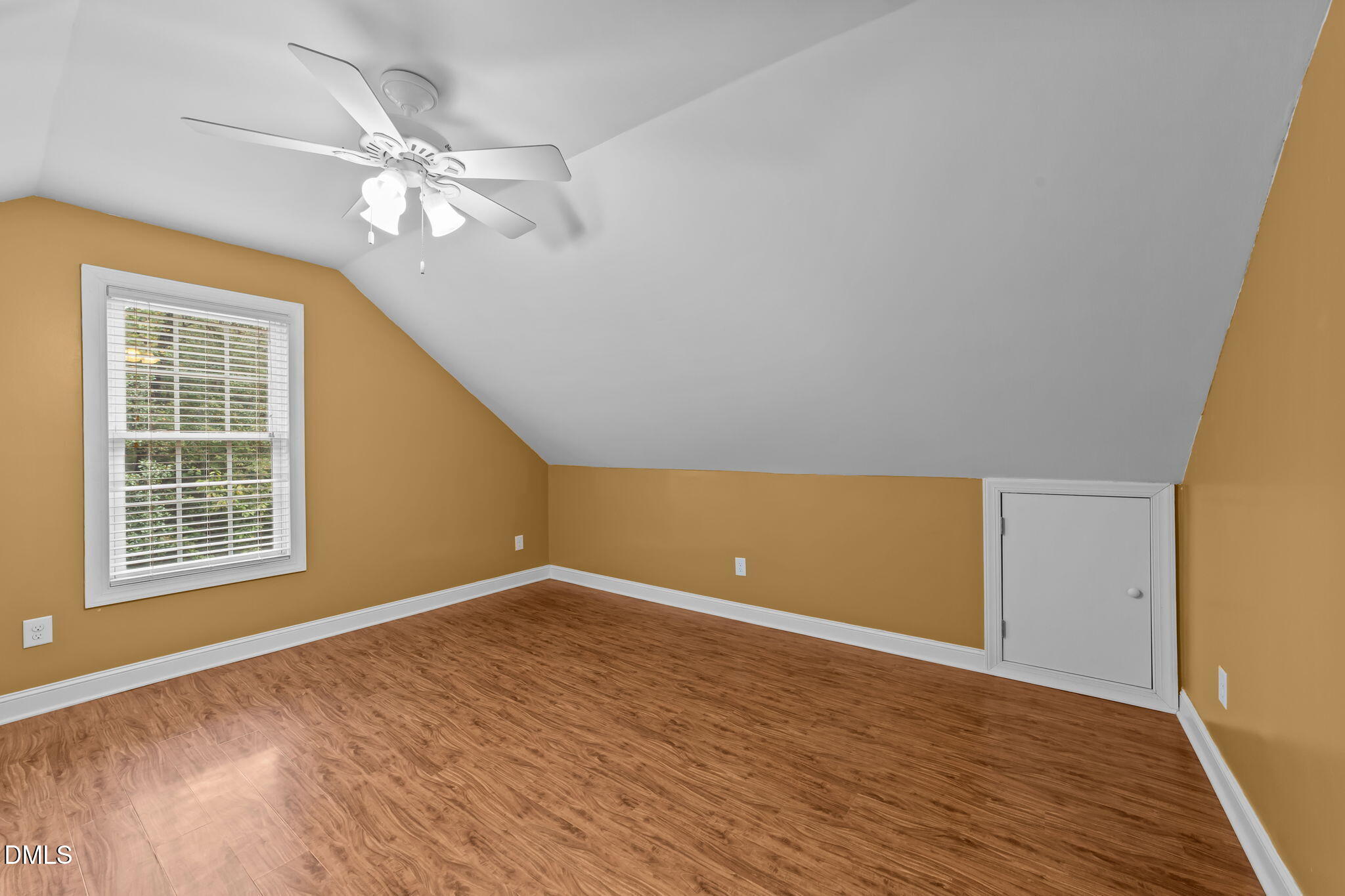 208 Adams Court Clayton, NC 27520 - Photo 38 of 63 a view of an empty room with wooden floor and a window