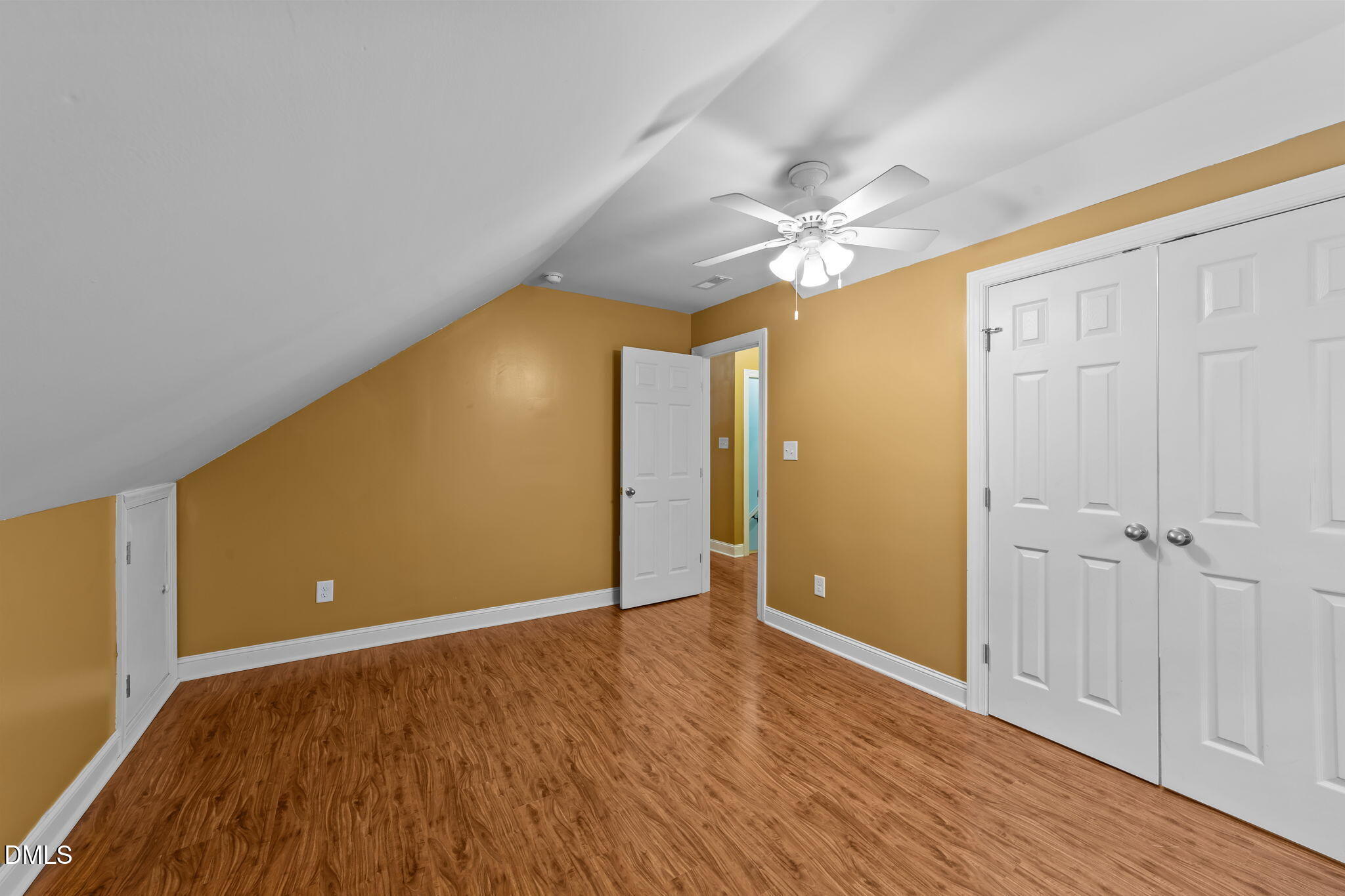 208 Adams Court Clayton, NC 27520 - Photo 39 of 63 a view of an empty room with window and wooden floor