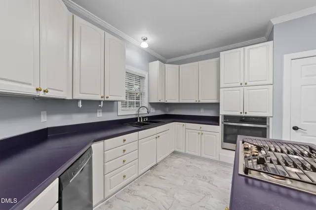 a kitchen with stainless steel appliances granite countertop a stove and a sink