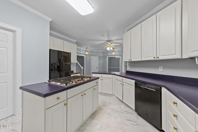 a kitchen with sink a stove and cabinets