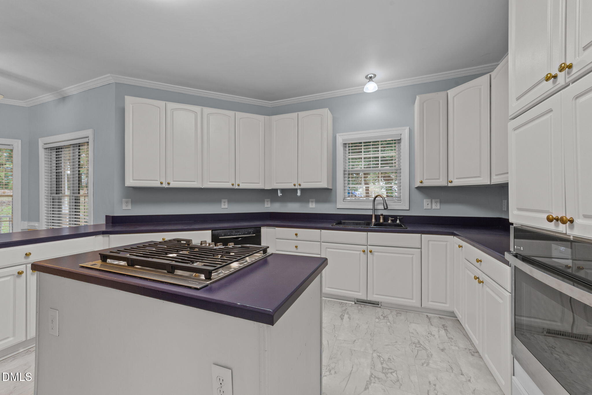 208 Adams Court Clayton, NC 27520 - Photo 10 of 63 a kitchen with sink a stove and cabinets
