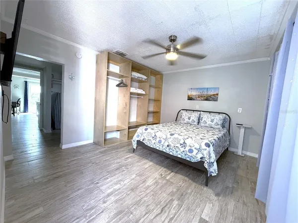 a bedroom with a bed and a large mirror