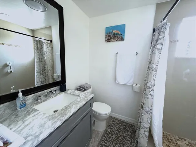 a bathroom with a sink a mirror and a shower