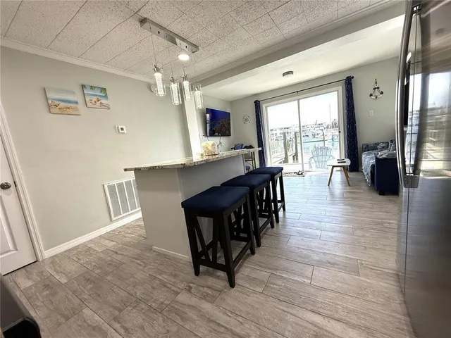 a living room with furniture and kitchen view