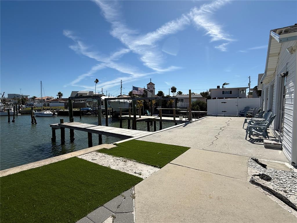 13711 Gulf Boulevard, Unit 1 Madeira Beach, FL 33708 - Photo 34 of 36 a view of a swimming pool with a chairs