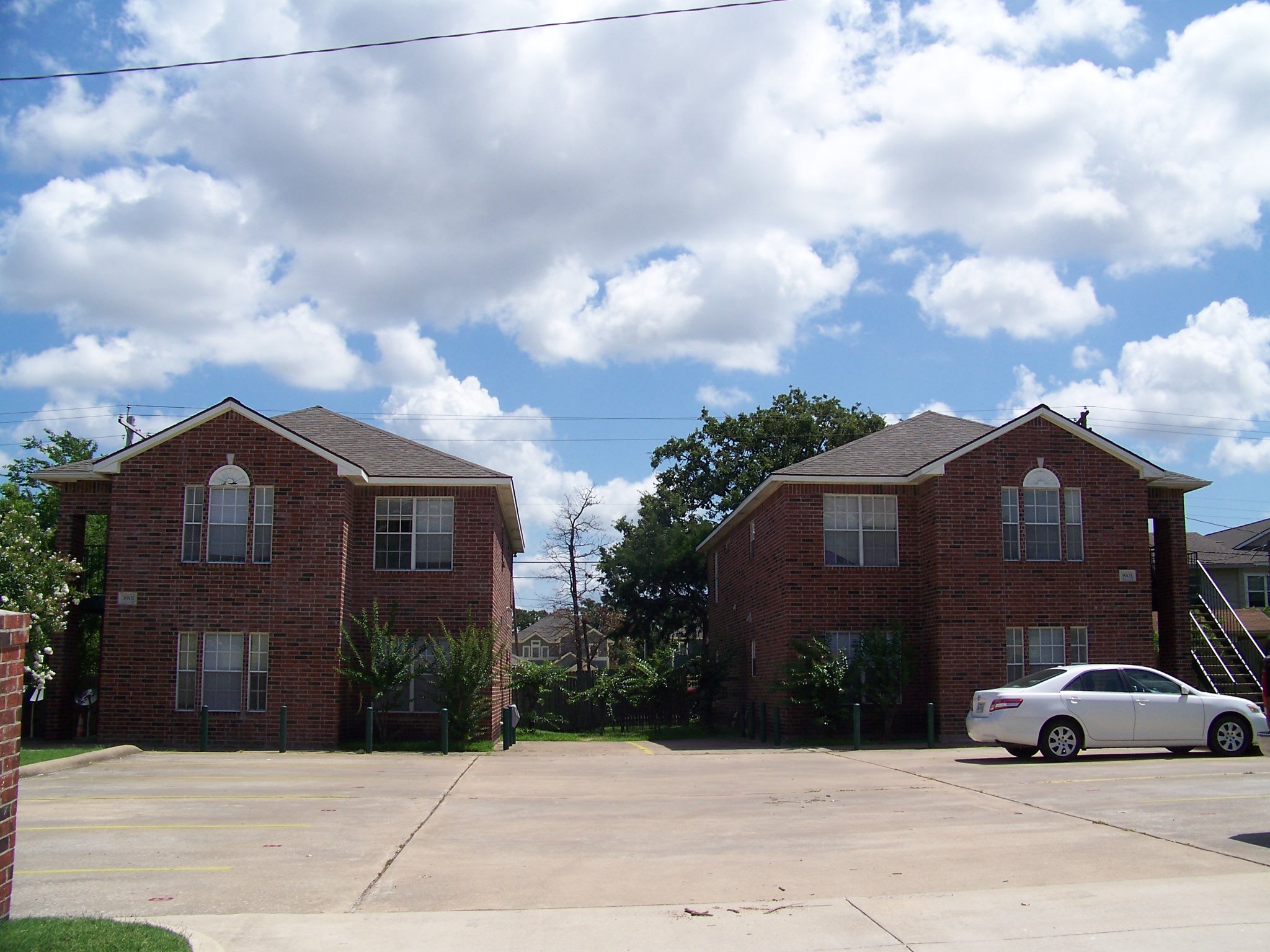 a view of a parked cars in front of house