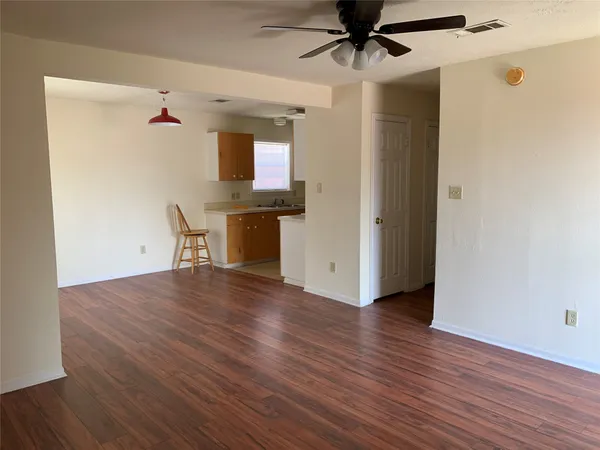 a view of a livingroom with wooden floor and a window