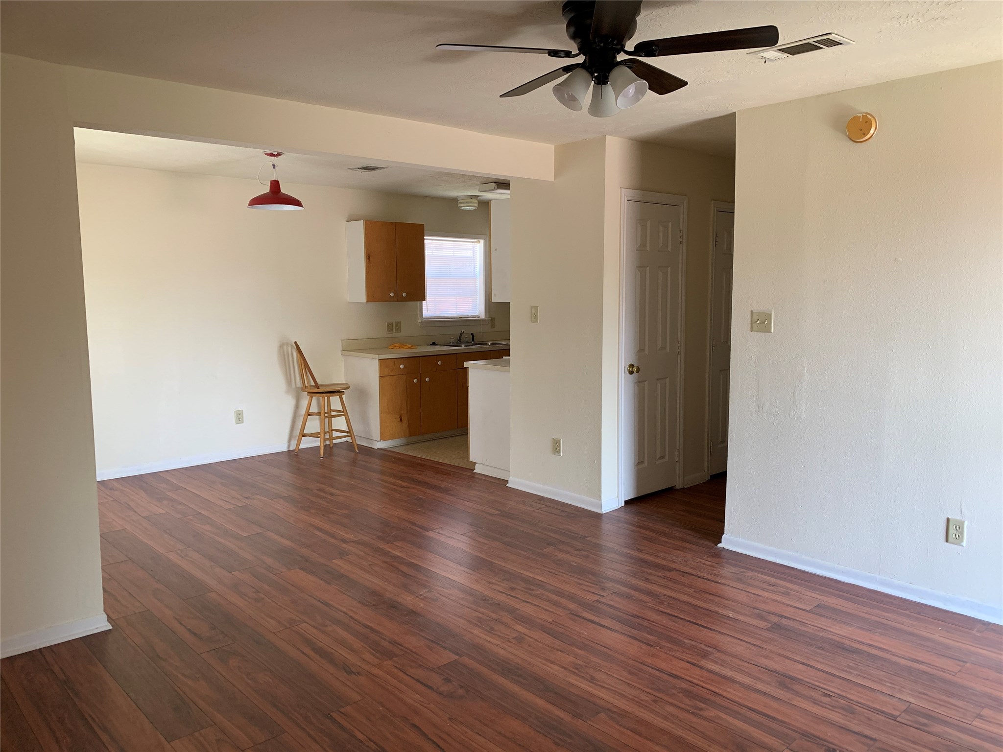 3901 College Main Street, Unit B Bryan, TX 77801 - Photo 11 of 25 a view of empty room with wooden floor and fan